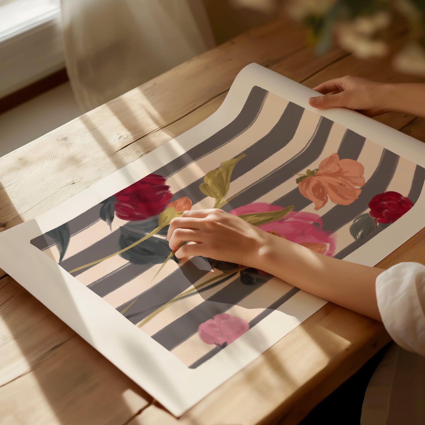 A painterly mix of pink and red roses art print on a striped cream and navy background