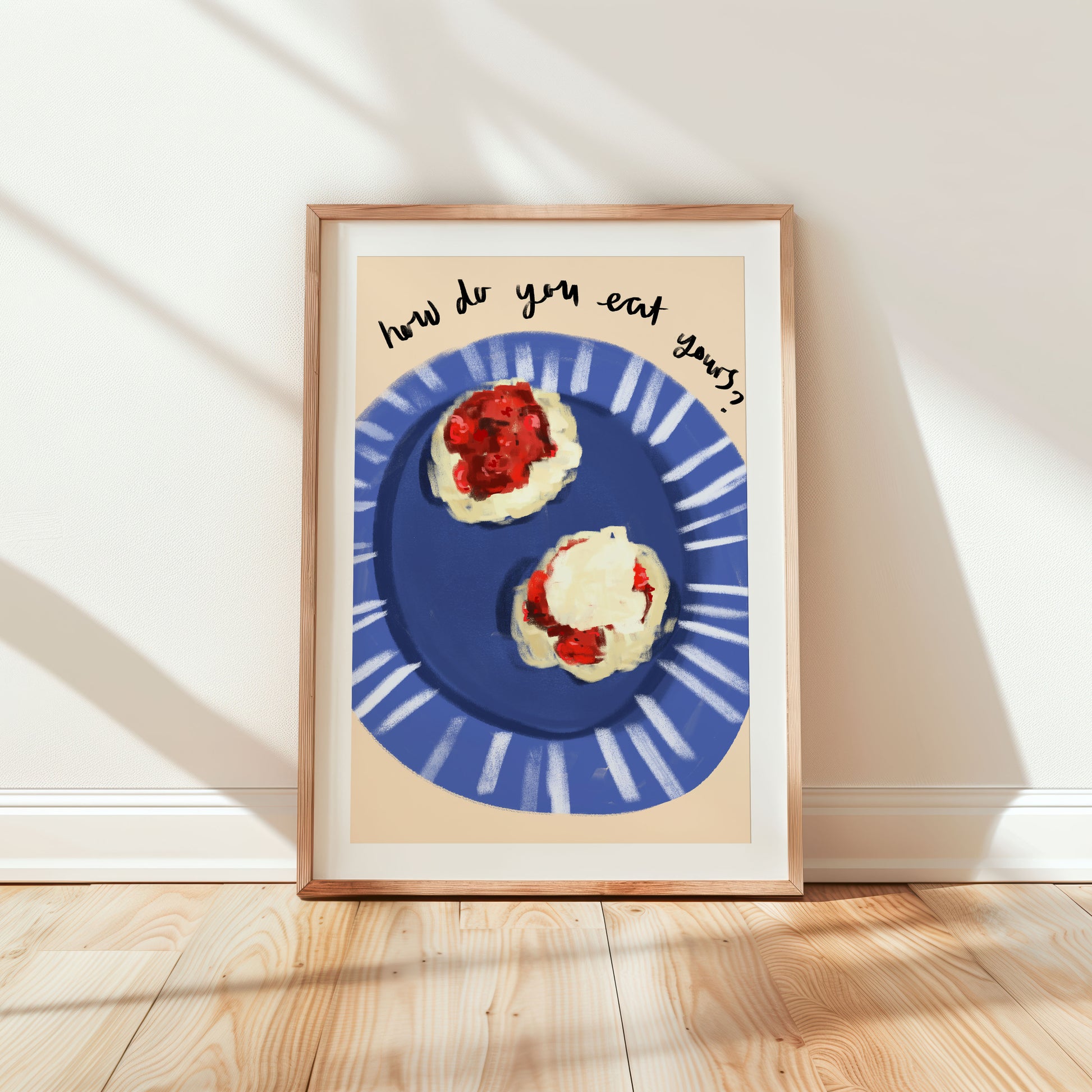 Bright kitchen wall art print featuring an illustration of scones with jam and cream.