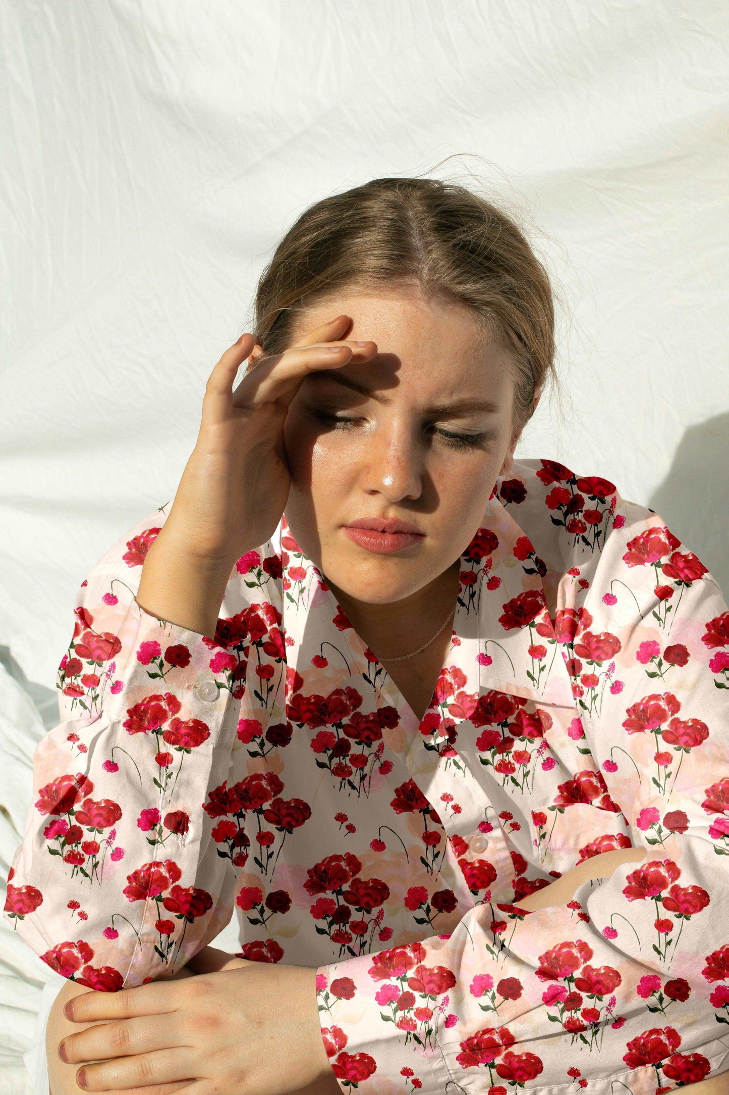 Red bouquet floral repeating textile pattern on a silk shirt